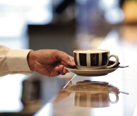 A server holding a coffee cup